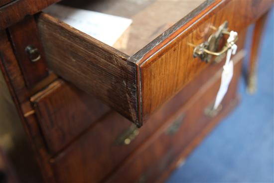 A George I featherbanded walnut bachelors chest, W.2ft 4in. D.1ft 1in. H.2ft 3in.